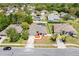 View of the home showcasing the screened-in pool, fenced in yard, and tidy landscaping at 1061 Archway Dr, Spring Hill, FL 34608