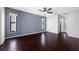A primary bedroom with hardwood floors, a ceiling fan, and lots of natural light at 1061 Archway Dr, Spring Hill, FL 34608