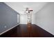 Spacious bedroom with a ceiling fan and dark wood floors at 1061 Archway Dr, Spring Hill, FL 34608