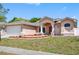 Charming single-story home featuring a well manicured front lawn at 1061 Archway Dr, Spring Hill, FL 34608