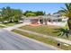 Lovely single-story home with a manicured lawn, elegant landscaping, and an attached two-car garage at 1061 Archway Dr, Spring Hill, FL 34608