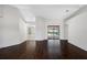Spacious living room featuring hardwood floors and a sliding glass door at 1061 Archway Dr, Spring Hill, FL 34608