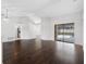 Living room featuring hardwood floors and a sliding glass door to the pool at 1061 Archway Dr, Spring Hill, FL 34608