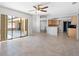 Open-concept living room and kitchen with tile floors and sliding glass doors to the patio at 1061 Archway Dr, Spring Hill, FL 34608