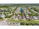 Aerial perspective of homes showcases community ponds, greenery, and residential properties in a planned layout at 11207 Flora Springs Dr, Riverview, FL 33579