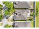 Aerial view of a neighborhood showcasing rooftops and verdant tree coverage at 11207 Flora Springs Dr, Riverview, FL 33579