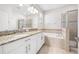 Luxurious bathroom with double vanities, granite countertops, soaking tub, and walk-in shower at 11207 Flora Springs Dr, Riverview, FL 33579