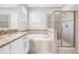 Bright bathroom featuring granite counters, a soaking tub, and a glass-enclosed shower at 11207 Flora Springs Dr, Riverview, FL 33579