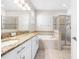 Bright bathroom featuring double sinks, vanity, soaking tub, and separate shower at 11207 Flora Springs Dr, Riverview, FL 33579