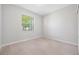 A simple bedroom with natural light, carpet flooring, and a closet for storage at 11207 Flora Springs Dr, Riverview, FL 33579