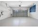 Spacious two-car garage featuring clean painted floors and ample storage space at 11207 Flora Springs Dr, Riverview, FL 33579