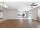 Open concept living area with hardwood floors connecting the kitchen and dining spaces at 11207 Flora Springs Dr, Riverview, FL 33579