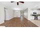Open-concept living space with hardwood floors that connects the kitchen with lots of natural light at 11207 Flora Springs Dr, Riverview, FL 33579