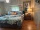 Relaxing bedroom features wood floors, colorful decor, and natural lighting at 12501 Ulmerton Rd # 216, Largo, FL 33774