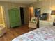 Spacious bedroom boasts wood floors, closet access, and light colored walls at 12501 Ulmerton Rd # 216, Largo, FL 33774
