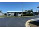 Exterior view showcasing landscaping and covered parking at 12501 Ulmerton Rd # 216, Largo, FL 33774