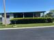 Home featuring covered parking and tidy landscaping at 12501 Ulmerton Rd # 216, Largo, FL 33774