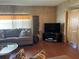 Living room area boasts wood paneling and large TV at 12501 Ulmerton Rd # 216, Largo, FL 33774