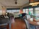 Cozy living room featuring a queen bed, gray sofa, ceiling fan and wood flooring at 12501 Ulmerton Rd # 216, Largo, FL 33774