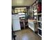 Organized workshop featuring a workbench, tool storage, and refrigerator at 12501 Ulmerton Rd # 216, Largo, FL 33774