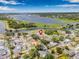 Aerial view of a residential neighborhood with a lake view, showing the home's location and surrounding greenery at 12641 98Th St, Largo, FL 33773