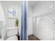 Updated bathroom with tile shower, turtle art, toilet, and green plant at 12641 98Th St, Largo, FL 33773
