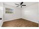 An empty bedroom featuring neutral walls, ceiling fan, window, and wood-look flooring at 12641 98Th St, Largo, FL 33773