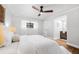The spacious main bedroom is bright and features a ceiling fan, a window, and an ensuite bathroom at 12641 98Th St, Largo, FL 33773