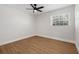 An empty bedroom featuring neutral walls, a ceiling fan, and wood-look flooring at 12641 98Th St, Largo, FL 33773