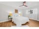 A bright bedroom with warm-toned floor, ceiling fan and neutral decor offers a relaxing atmosphere at 12641 98Th St, Largo, FL 33773