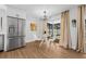 A modern dining area next to the kitchen features a stainless steel refrigerator and stylish decor at 12641 98Th St, Largo, FL 33773