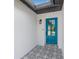 Stylish front entryway featuring decorative tile flooring and a modern blue door with glass inserts at 12641 98Th St, Largo, FL 33773