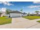 View of a house with clean landscaping and a paved driveway leading to the attached garage at 12641 98Th St, Largo, FL 33773