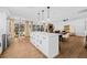 Open-concept living with a large island, stainless steel refrigerator, and dining area with backyard views at 12641 98Th St, Largo, FL 33773