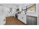 A modern kitchen features stainless steel appliances, white cabinets, and a large window above the sink at 12641 98Th St, Largo, FL 33773