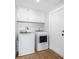 A well-lit laundry room features modern white appliances and ample storage space at 12641 98Th St, Largo, FL 33773