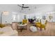 Bright, open-concept living space connecting the living room, dining area, and kitchen with lots of natural light at 12641 98Th St, Largo, FL 33773
