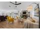 Open-concept living space with wood floors, stone fireplace, and combined dining and kitchen area at 12641 98Th St, Largo, FL 33773