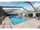 A view of a screened-in pool and patio area featuring an outdoor living space at 12641 98Th St, Largo, FL 33773
