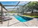 An inviting, private screened-in pool with lounge chairs and ample patio space at 12641 98Th St, Largo, FL 33773