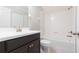 Modern bathroom boasts a vanity with dark cabinets, a white sink, and tub-shower combination at 13334 Palmera Vista Dr, Riverview, FL 33579
