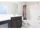 Bright bathroom features a vanity with dark cabinets and a shower-tub combination at 13334 Palmera Vista Dr, Riverview, FL 33579