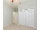 Bedroom with a closet, light carpet, neutral walls, and doors leading to other rooms at 13334 Palmera Vista Dr, Riverview, FL 33579