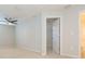 Bright bedroom with carpet floors, neutral walls, and a door to an adjoining bathroom at 13334 Palmera Vista Dr, Riverview, FL 33579