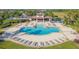 A luxury community pool boasts plenty of seating, covered seating areas, and green spaces at 13334 Palmera Vista Dr, Riverview, FL 33579
