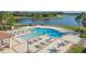 An aerial shot of a resort style community pool with lounge chairs and water views at 13334 Palmera Vista Dr, Riverview, FL 33579
