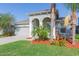 Beautiful single-story home showcasing an attached two-car garage, arched entryway, and landscaped front yard at 13334 Palmera Vista Dr, Riverview, FL 33579