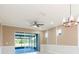 Living room with sliding glass doors leading to screened patio and decorative ceiling fan at 13334 Palmera Vista Dr, Riverview, FL 33579