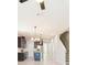 Bright and airy living space with a view of the modern kitchen and staircase at 13334 Palmera Vista Dr, Riverview, FL 33579
