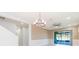 Open-concept living room with large sliding doors to screened-in patio and modern chandelier at 13334 Palmera Vista Dr, Riverview, FL 33579